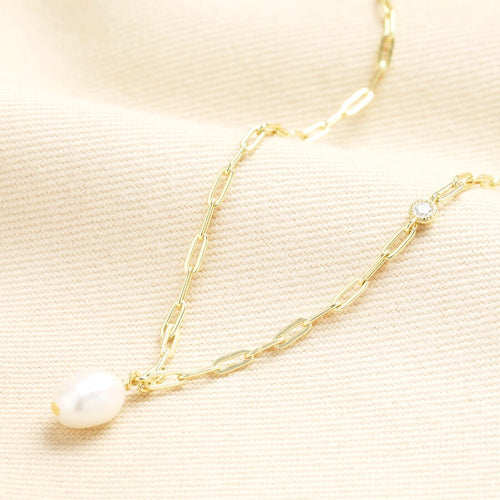 Gold chain necklace with a freshwater pearl displayed.