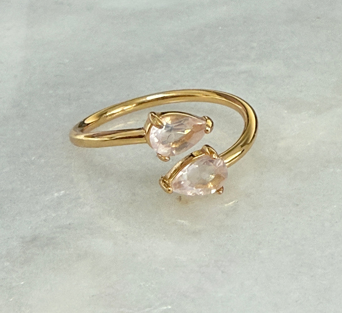 two pear-shaped pink gemstones gold banded adjustable ring 