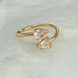 two pear-shaped pink gemstones gold banded adjustable ring 