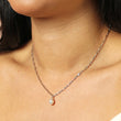 silver chain Necklace with a pearl pendant and crystal drop worn by a person