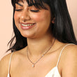 Woman wearing a silver paperclip chain necklace with a freshwater pearl pendant 