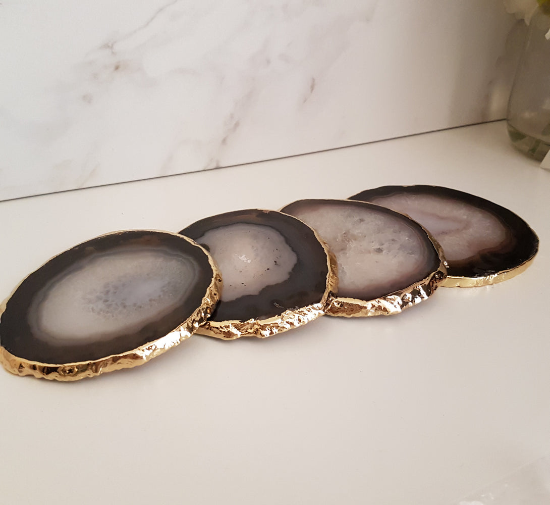 set of black crystal coasters made of Agate crystal from brazil with gold glided edge.