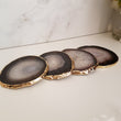 set of black crystal coasters made of Agate crystal from brazil with gold glided edge.
